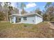 The backyard features a covered patio, window views, and utility access for outdoor comfort at 12876 Se 42Nd Ct, Belleview, FL 34420