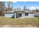 A view of the home's rear exterior shows a covered patio and a sliding glass door entrance at 12876 Se 42Nd Ct, Belleview, FL 34420
