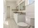 Bathroom featuring a double sink vanity, grey tile flooring, framed mirrors, and modern fixtures at 12876 Se 42Nd Ct, Belleview, FL 34420