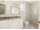 Modern bathroom with a luxurious vanity and a glass walk-in shower for a spa-like experience at 12876 Se 42Nd Ct, Belleview, FL 34420