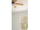 Partial view of bedroom with white walls and trim with a light colored ceiling fan at 12876 Se 42Nd Ct, Belleview, FL 34420