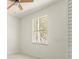 A room with a window to view nature and a ceiling fan that creates a relaxing ambiance at 12876 Se 42Nd Ct, Belleview, FL 34420