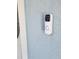 A modern doorbell camera on the exterior wall provides added security and convenience at 12876 Se 42Nd Ct, Belleview, FL 34420