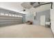 Spacious garage with epoxy floors, roll-up door and utility sink at 12876 Se 42Nd Ct, Belleview, FL 34420