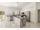 Bright kitchen with white cabinetry, stainless steel appliances, and marble countertop island at 12882 Se 42Nd Ct, Belleview, FL 34420