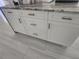 Kitchen cabinets with long, stylish gold handles and stone countertops at 12876 Se 42Nd Ct, Belleview, FL 34420