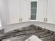 Upper kitchen cabinets are white with glass inserts and gold hardware at 12876 Se 42Nd Ct, Belleview, FL 34420