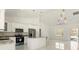 Modern kitchen with stainless steel appliances, granite countertops, and a large island that enhances the open floor plan at 12876 Se 42Nd Ct, Belleview, FL 34420