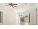 Spacious living room and kitchen featuring high ceilings, white walls and floors with white kitchen cabinets at 12876 Se 42Nd Ct, Belleview, FL 34420