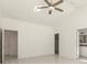 A spacious main bedroom with ensuite access and a ceiling fan for a comfortable living space at 12876 Se 42Nd Ct, Belleview, FL 34420