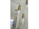 Stylish gold and glass pendant lights add modern elegance to this home's interior design at 12876 Se 42Nd Ct, Belleview, FL 34420