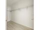 Walk-in closet features white walls and metal shelving for organized storage at 12876 Se 42Nd Ct, Belleview, FL 34420