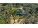 Beautiful aerial view of a bright white home set amidst green lawns and mature trees at 13751 Sw 49Th Pl, Ocala, FL 34481