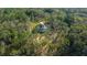 A tranquil aerial shot reveals a private home nestled within a dense grove of trees at 13751 Sw 49Th Pl, Ocala, FL 34481