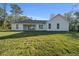 Rear exterior with covered patio and sliding glass doors that enhance indoor-outdoor flow at 13751 Sw 49Th Pl, Ocala, FL 34481
