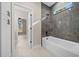 Bathroom with a large, tiled shower and a deep soaking tub at 13751 Sw 49Th Pl, Ocala, FL 34481