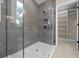 Modern bathroom featuring a glass enclosed shower with gray tile and a large walk-in closet at 13751 Sw 49Th Pl, Ocala, FL 34481