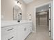 Bright bathroom with double vanity, quartz countertop and access to a large walk-in closet at 13751 Sw 49Th Pl, Ocala, FL 34481