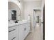 Bright bathroom featuring a dual sink vanity with a white countertop and modern black hardware at 13751 Sw 49Th Pl, Ocala, FL 34481