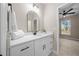 Bathroom featuring bright lighting, single sink, sleek faucet and white cabinets at 13751 Sw 49Th Pl, Ocala, FL 34481
