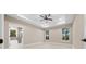 Serene bedroom with tray ceiling, neutral walls, and two windows offering natural light and outdoor views at 13751 Sw 49Th Pl, Ocala, FL 34481