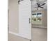 Bedroom featuring a modern sliding barn door with an attached office space at 13751 Sw 49Th Pl, Ocala, FL 34481