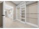 Large walk-in closet with custom shelving and access to bathroom with double vanity at 13751 Sw 49Th Pl, Ocala, FL 34481