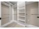 Large walk-in closet with custom shelving and chrome hanging racks at 13751 Sw 49Th Pl, Ocala, FL 34481