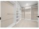 Large walk-in closet with custom shelving and chrome hanging racks at 13751 Sw 49Th Pl, Ocala, FL 34481
