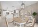 Dining room featuring an oval wooden table with seating for six, decorative lighting, and kitchen views at 13751 Sw 49Th Pl, Ocala, FL 34481