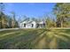Exterior view of a modern farmhouse featuring a manicured lawn and white siding at 13751 Sw 49Th Pl, Ocala, FL 34481