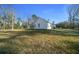 View of home exterior showing lawn and trees, creating a peaceful and private atmosphere at 13751 Sw 49Th Pl, Ocala, FL 34481