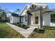 Charming home featuring black trim, a modern front door, and freshly installed landscaping at 13751 Sw 49Th Pl, Ocala, FL 34481