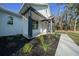 Charming front entrance with dark columns and professionally landscaped flowerbeds at 13751 Sw 49Th Pl, Ocala, FL 34481