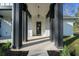 Inviting front porch featuring dark columns and modern design elements at 13751 Sw 49Th Pl, Ocala, FL 34481