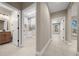 Hallway providing access to the bathroom, laundry room, and a bedroom with natural light at 13751 Sw 49Th Pl, Ocala, FL 34481