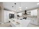 Stylish kitchen with a spacious island featuring seating, pendant lights, and modern appliances at 13751 Sw 49Th Pl, Ocala, FL 34481