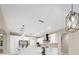 Open floor plan with white kitchen, stainless steel appliances, and a large kitchen island at 13751 Sw 49Th Pl, Ocala, FL 34481