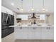 Modern kitchen boasts a large island, pendant lights, stainless appliances and quartz countertops at 13751 Sw 49Th Pl, Ocala, FL 34481