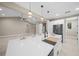 Spacious kitchen island with a farmhouse sink and plenty of counter space and decorative lighting at 13751 Sw 49Th Pl, Ocala, FL 34481