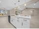 Kitchen island featuring a white farmhouse sink, seating, modern pendants and stainless steel appliances at 13751 Sw 49Th Pl, Ocala, FL 34481