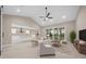 Open-concept living room with a view into the kitchen and access to the outdoors through sliding glass doors at 13751 Sw 49Th Pl, Ocala, FL 34481