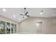 Spacious living room with high ceilings, recessed lighting, and sliding glass doors to the outdoors at 13751 Sw 49Th Pl, Ocala, FL 34481