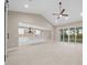 Open-concept living space connects kitchen with island, dining, and living area, featuring neutral tones and ample natural light at 13751 Sw 49Th Pl, Ocala, FL 34481