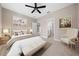 Staged main bedroom with neutral walls, decor, and adjoining ensuite access at 13751 Sw 49Th Pl, Ocala, FL 34481