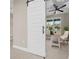 Bright home office featuring a modern sliding barn door at 13751 Sw 49Th Pl, Ocala, FL 34481
