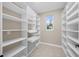 Walk-in pantry featuring custom shelving, drawers, and storage space at 13751 Sw 49Th Pl, Ocala, FL 34481