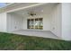Covered back patio with ceiling fan and sliding glass doors to seamlessly blend indoor and outdoor living at 13751 Sw 49Th Pl, Ocala, FL 34481