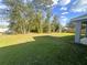 Spacious backyard with well-maintained lawn and mature trees providing privacy and shade at 15055 Se 93Rd Ct, Summerfield, FL 34491
