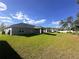 Expansive backyard with lush green grass and covered patio, ideal for outdoor entertaining at 15055 Se 93Rd Ct, Summerfield, FL 34491